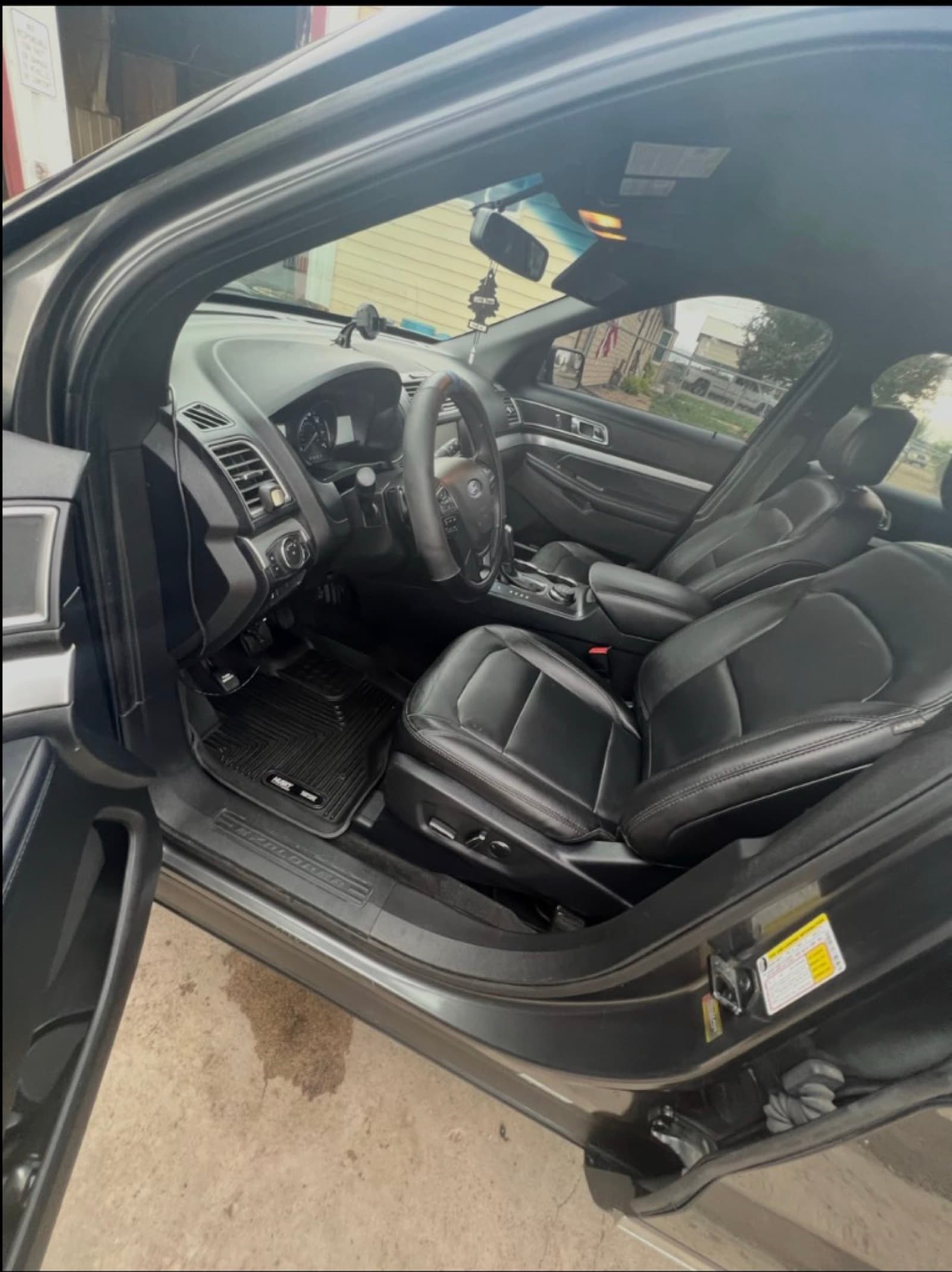 SUV front interior after detail — clean leather seats and dash, driver side