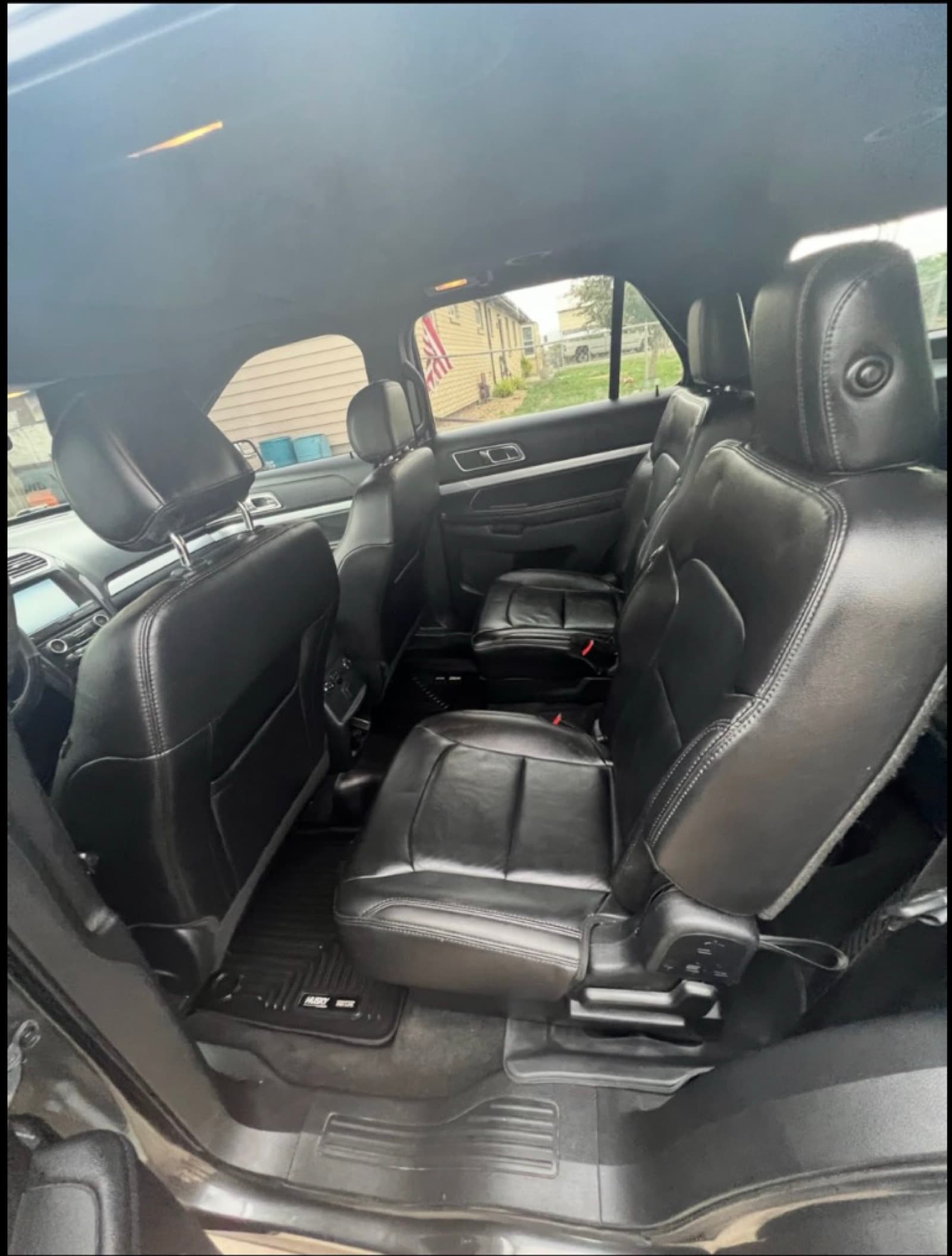 SUV rear interior after detail — clean second-row leather seats